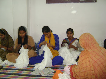 women in Delhi sewing beads by hand