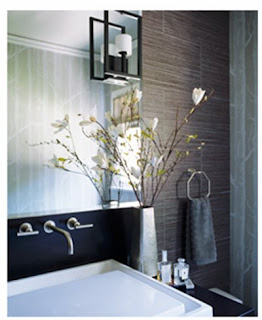 Modern bathroom with black vanity and tile walls