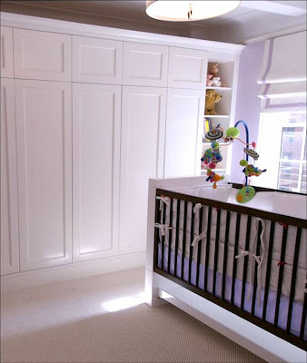 Doors to a built in closet in a New York nursery by Area Interior Design