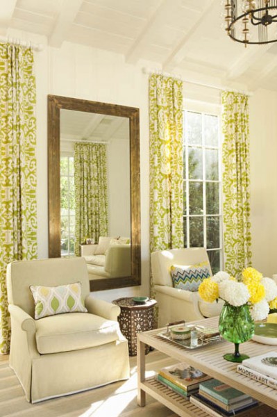 Cherry pool house with bright yellow and green accents and a large bronze mirror