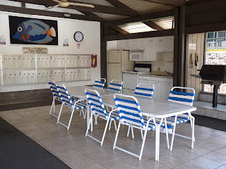 BBQ and kitchen in common area next to swimming pool
