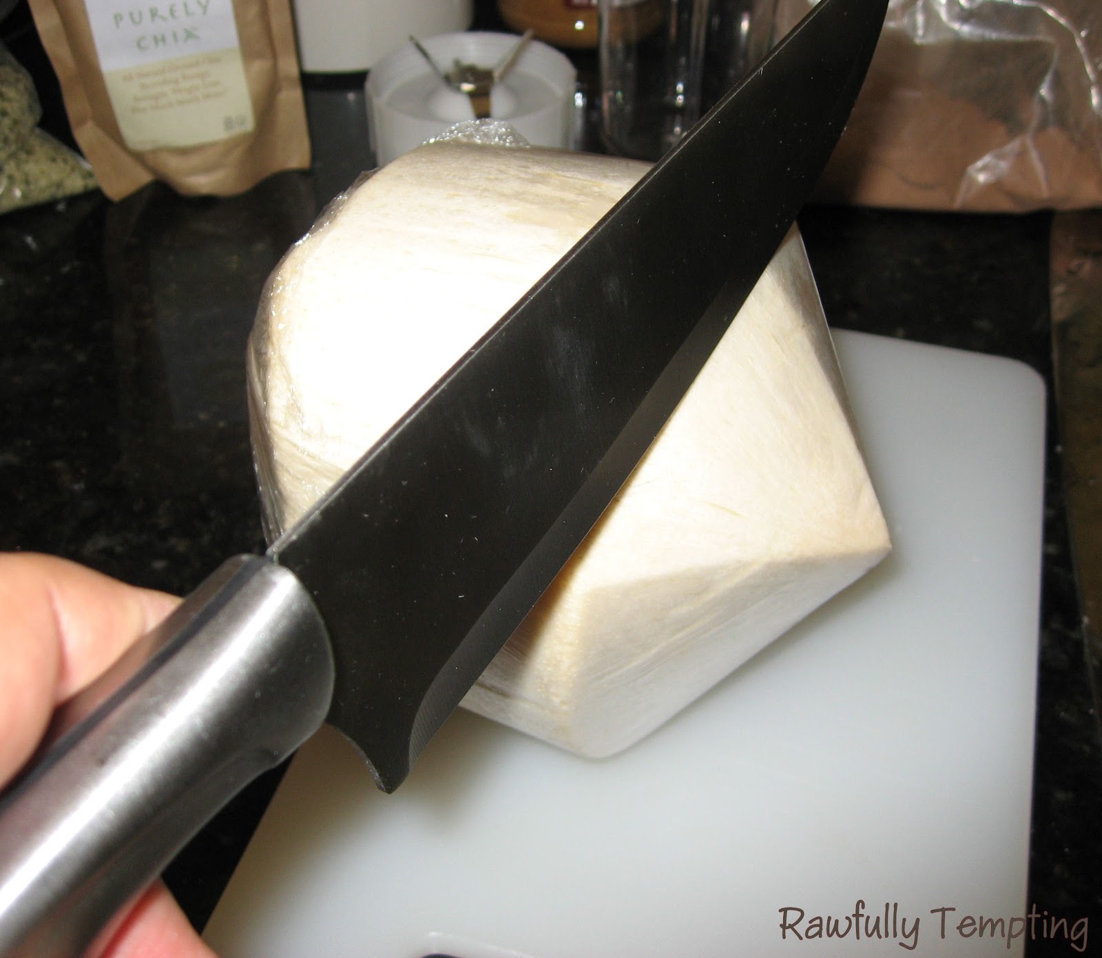 Laying coconut on side (I'm holding knife in wrong hand just to take