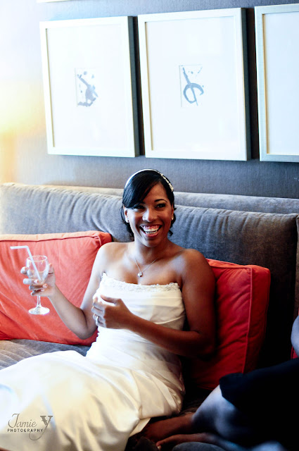 Happy Mandalay Bay Bride Bride smiling on couch holding a glass of champagne
