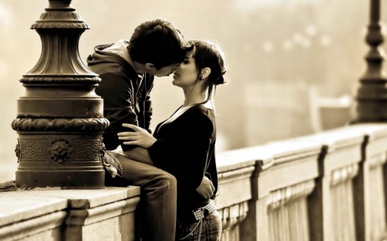 young couple kissing in rain. young couple kissing in the