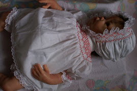 White cotton with red smocking.