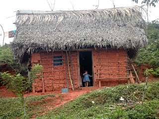 Honduran girl in clay house