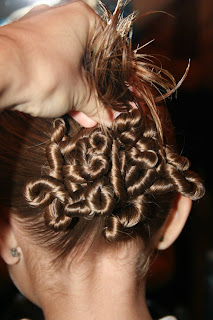 Young girl's hair being styled in to "Ponytail Of Twists" hairstyle