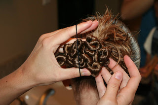 Young girl's hair being styled in to "Ponytail Of Twists" hairstyle