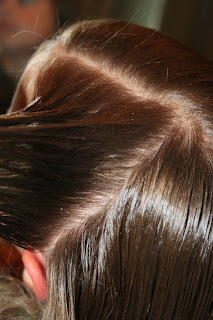Close up view of young girl's hair being styled into "Wrap-Around French Braid" hairstyle
