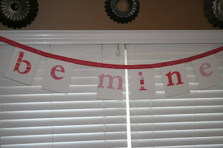 "Be Mine" Valentine's banner hanging on a window seal