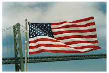 Flag at the stern of the Battleship New Jersey, at dock beside the San Francisco-Oakland Bay Bridge