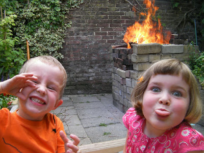 fire and abuse. 2 happy children pulling faces and a bonfire