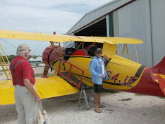 Fred with Paul the Pilot and Paul's  plane.  Note the lack of enclosure for passengers.