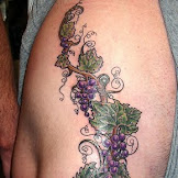 Grape Vine Tattoo Designs - Tattoo Project 2005 : The combination of wild flowers and vines is one that occurs in nature and looks impressive every time, even as a tattoo.