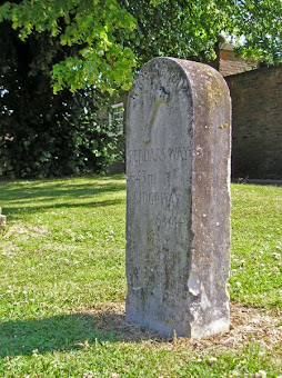 On the left, Basham village green. On the right, Icknield Way milestone - 43 miles to the Peddars Way, 63 miles to the Ridgeway.