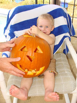 Kaleb holding the pumpkin he "helped" his daddy carve.