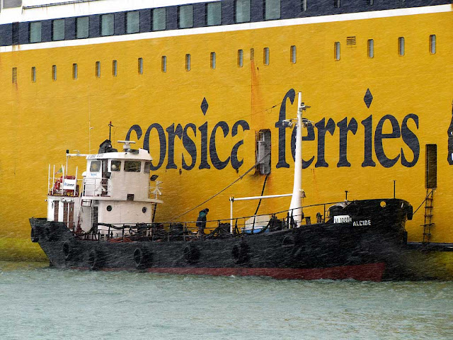 Small tanker and a ferry under the snow, port of Livorno