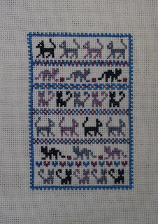 cross stitch of many simple cats