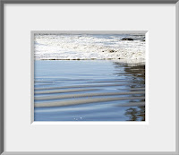 A framed photo of shimmering ripples of wet sand and foamy blue surf advancing up the beach capture the aura of the wild coast of Olympic National Park.