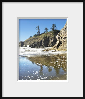 framed photo of rocky cliffs, brilliant blue sky and all of the wildness of a Pacific coast