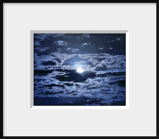 A framed photo of the full moon at twilight is reflected in a cloudy sky and is presented in a monochromatic blue.