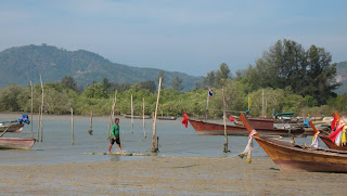 Fisherman and longtail boats
