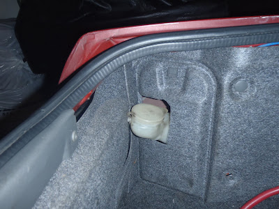 Hidden  windshield washer fluid resveroir in trunk