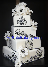 Four tier square white fondant wedding cake