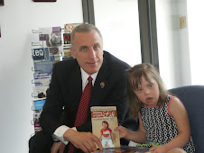 Chloe presents an autographed copy of book to her US Congressman Tim Murphy