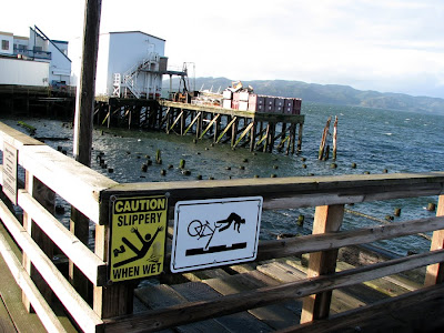 Slippery When Wet and Bicycle Safety Sign at Pier 11, Astoria, Oregon