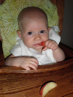 Baby eating peaches