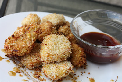 plate of crispy chicken bites with a small bowl of barbecue sauce