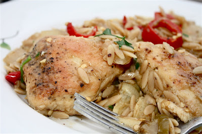 plate with chicken, artichokes, and orzo