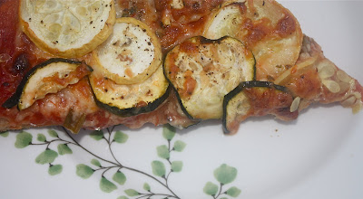 plate of pizza topped with squash and zucchini 