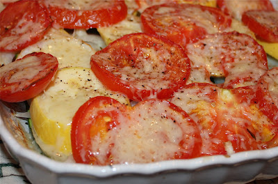 baking tin of tomatoes and squash covered in cheese