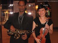 An image of the saxophone and violin player