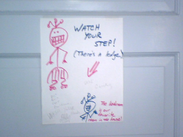 Watch your step! There's a ledge & funny stick people.