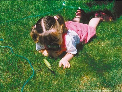 NAMC montessori twos activity presentation observing nature close up girl on the grass