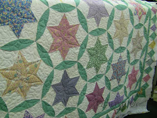 Stars with Modified Prairie Point Border with custom quilting by Angela Huffman - QuiltedJoy.com