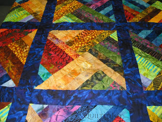 Luscious Batik Strip Quilt with Pretty Posie Panto, edge to edge quilting by Angela Huffman - QuiltedJoy.com
