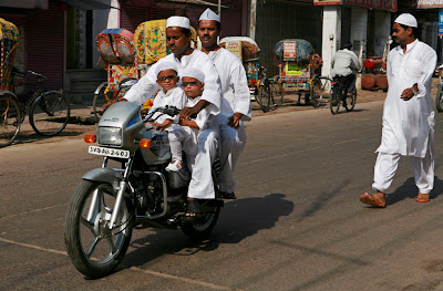 eid10 Indian Muslims ride a motor bike to offer Eid al Fitr prayers at a mosque in Allahabad, India
