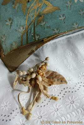 A broach decorated with delicate wax flowers