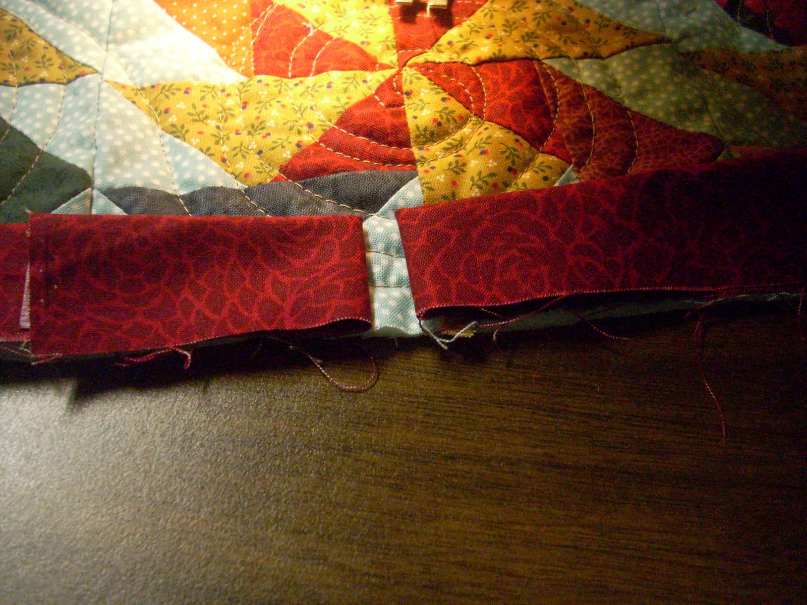 Folded back ends of binding on a quilt