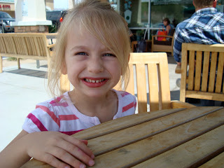 Young girl sitting at table smiling
