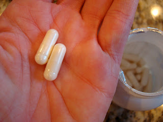Two probiotic capsules in hand