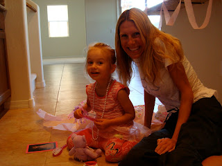 Woman and young girl sitting on floor smiling