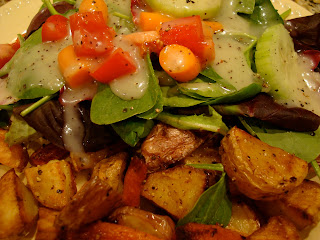 Dressed salad served with roasted vegetables