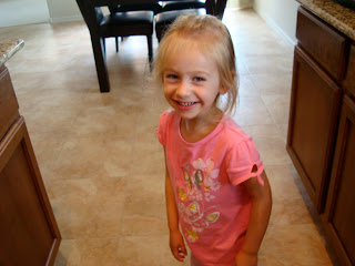 Little girl smiling standing in kitchen