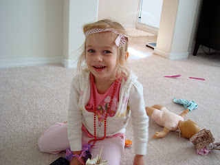 Young girl playing dress up with toys