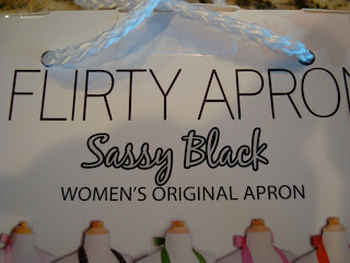 Box saying Flirty  Apron Sassy  Black